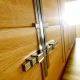 Wooden cabinet doors with modern hinges in bright natural lighting.