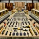 Organized workshop with cabinet hinges and assembly tools.